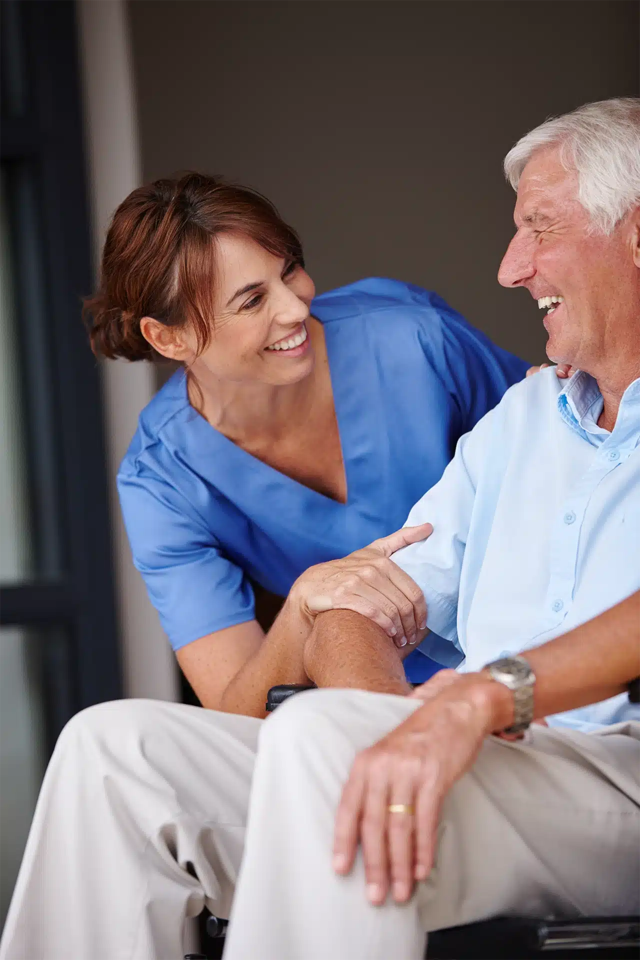 Home Health Nurse in Florida speaking to an elderly man and both are smiling