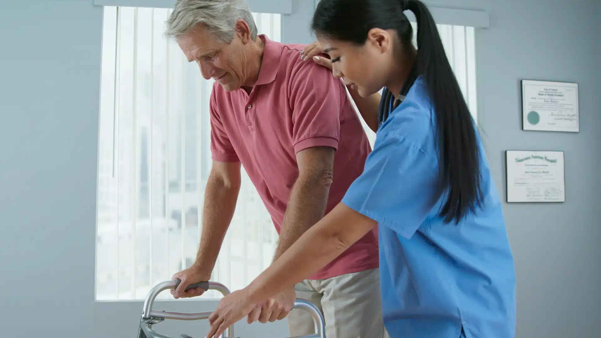 Home health aide helping a senior with mobility in his home