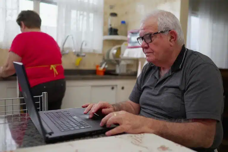 Senior using a laptop at home