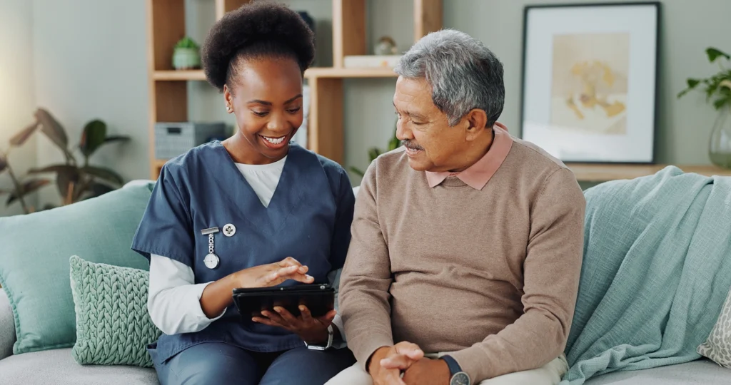 Home health nurse reviewing care information with a senior patient at home in Fort Lauderdale, FL