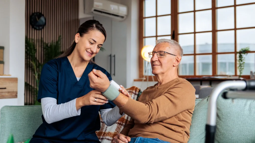 A healthcare professional checking the blood pressure of an elderly person in Fort Lauderdale, FL