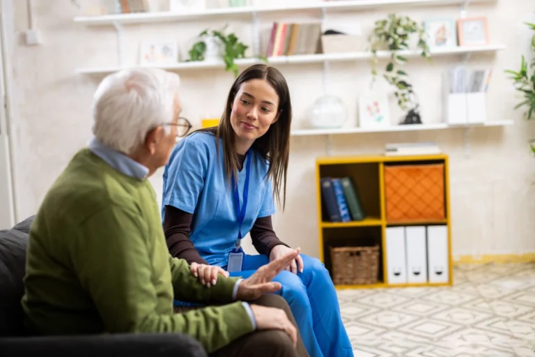 Caregiver offering a drink and support to an elderly person in Central & Southern FL