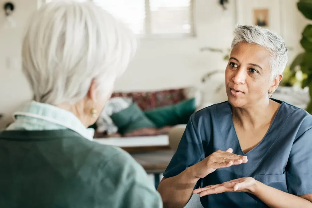 Care worker talking with a patient about Dementia & Alzheimer’s Care in Central & Southern Florida
