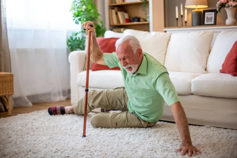 An elderly man stumbles and falls onto the carpet of his home in Central or Southern Florida