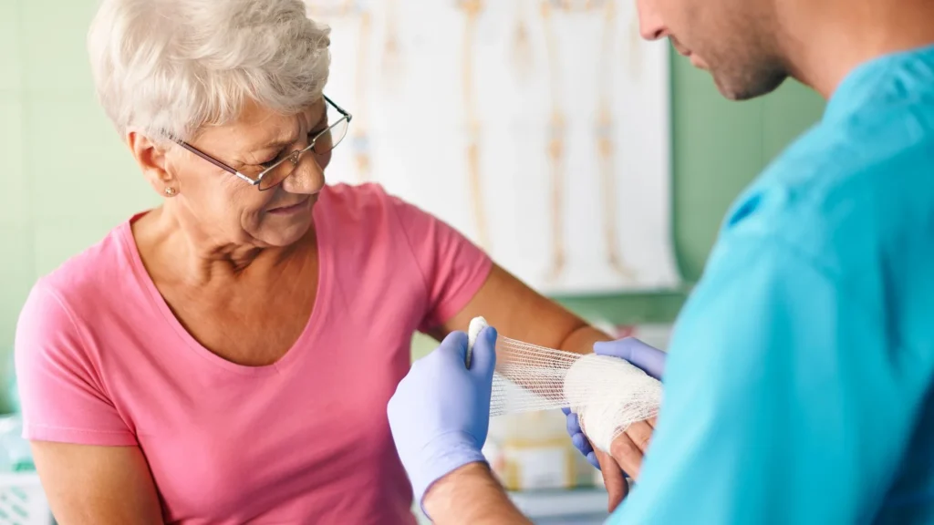 Healthcare professional wrapping a bandage on an older adult's forearm in Central & Southern Florida
