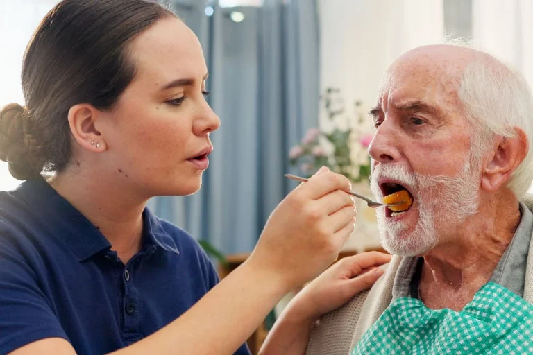 Care worker assisting low sodium meal