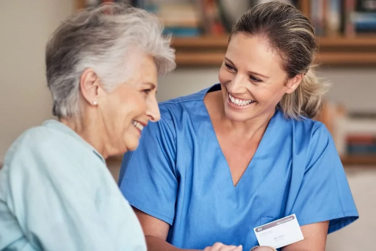 Healthcare worker sitting with an adult providing caregiving in Central & Southern Florida