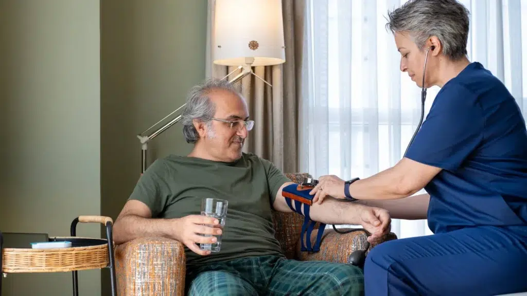 A healthcare worker measuring blood pressure at home in Central & Southern Florida