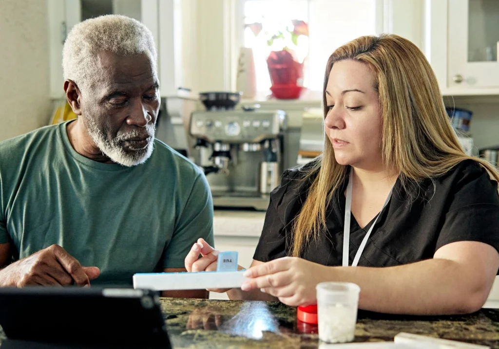 Caregiver assisting an elderly person with medication in Naples, FL