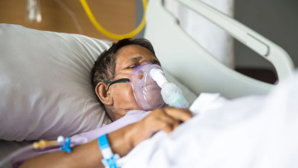 Patient lying on a bed with a ventilator and medical equipment in Central & Southern Florida